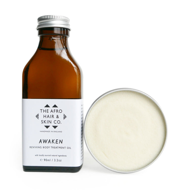 GLOWY BODY SET. Awaken reviving body treatment oil and open jar of Native Glow organic shea butter skincare set on white background. Skincare for black people.