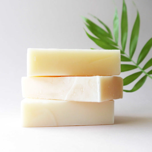 NURTURE - Gentle Cleansing Shampoo Bar. Stack of three shampoo soap bars on soft neutral background. Afro hair shampoo. Haircare products for afro hair