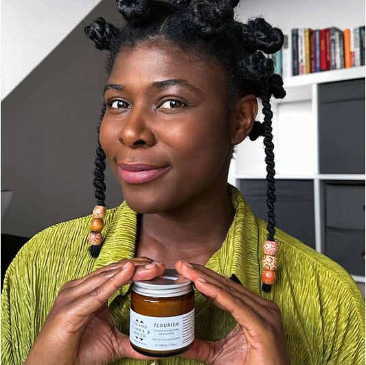 FLOURISH-Totally Nourishing Hair Butter pretty black woman holding a jar of afro hair product